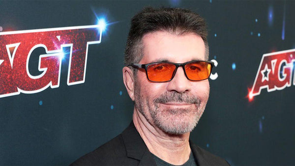 Man wearing sunglasses with 'AGT' logo in the background